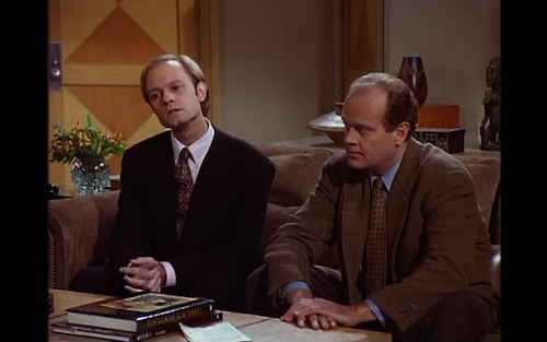 Niles and Frasier sit on Frasier's couch